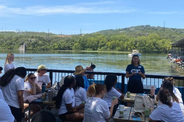 Christine leading a team with Oracle as part of their standup paddleboard cleanup event on Lake Austin, May 2025