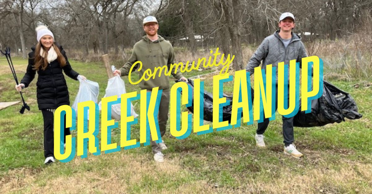 community volunteers cleaning up a creek and collecting litter outdoors