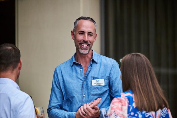 Board President Justin Westmoreland chatting with guests at the cocktail reception