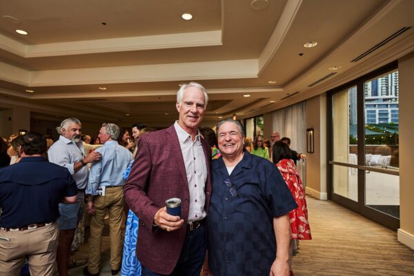 two guests smiling together at the indoor cocktail reception
